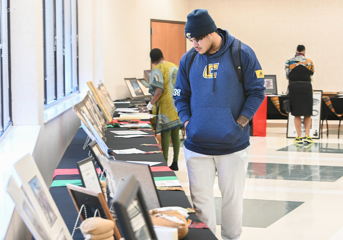Austin Collier looks at items in the Sankofa African American Museum on Wheels exhibit Friday, Feb. 28, 2020 in the University Center.